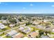 Bright aerial view of a single-story home in a vibrant residential community with lush landscaping and mature trees at 1616 Bayhill Dr, The Villages, FL 32159