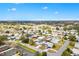 Aerial view of a neighborhood with tree-lined streets and well-maintained homes and lawns at 1616 Bayhill Dr, The Villages, FL 32159
