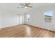 Bedroom with vaulted ceiling, fan, light wood floors, and view to the outside at 1616 Bayhill Dr, The Villages, FL 32159