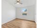 Bright bedroom with a ceiling fan, light walls and wood-look flooring and a window for lots of natural light at 1616 Bayhill Dr, The Villages, FL 32159