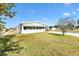 Well-kept single-story home featuring a screen room and green lawn, providing a comfortable living environment at 1616 Bayhill Dr, The Villages, FL 32159