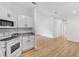 Open-concept kitchen with sleek white cabinetry, granite counters, and modern appliances flows into adjacent living spaces at 1616 Bayhill Dr, The Villages, FL 32159