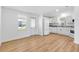 Bright kitchen with new white cabinets, appliances, and wood floor, perfect for cooking and entertaining at 1616 Bayhill Dr, The Villages, FL 32159