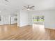 Open living area with view to kitchen; light wood flooring and neutral walls at 1616 Bayhill Dr, The Villages, FL 32159