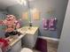 Bathroom featuring a sink with modern fixtures, toilet, mirror, wall decorations, and decor at 167 N Cervidae Dr, Apopka, FL 32703