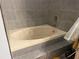 A clean bathroom features a simple tub and attractive gray tile at 167 N Cervidae Dr, Apopka, FL 32703