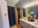 Bathroom featuring a double vanity with a shower-tub combination and modern fixtures at 167 N Cervidae Dr, Apopka, FL 32703
