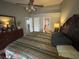 Spacious bedroom with vaulted ceilings, dresser, and ensuite bathroom, offering a serene retreat for relaxation and privacy at 167 N Cervidae Dr, Apopka, FL 32703