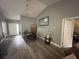 Bright dining room featuring wood-look floors, vaulted ceilings, and stylish chandelier, perfect for Gathering meals and entertaining at 167 N Cervidae Dr, Apopka, FL 32703