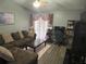 Inviting living room featuring comfortable seating, a ceiling fan, and large window that brings in ample natural light at 167 N Cervidae Dr, Apopka, FL 32703