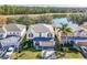 Aerial view of a two story house with a lake and trees in the background at 16825 Sunrise Vista Dr, Clermont, FL 34714