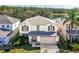 Aerial view of the house with a lake in the background at 16825 Sunrise Vista Dr, Clermont, FL 34714