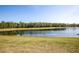 Expansive lake view displaying clear waters and a tree-lined shore against a clear blue sky at 16825 Sunrise Vista Dr, Clermont, FL 34714