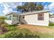 House exterior showcasing a sunroom and a well-maintained lawn at 17145 Se 93Rd Yondel Cir, The Villages, FL 32162