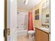 Updated bathroom with tub shower, granite vanity, and coral shower curtain at 17145 Se 93Rd Yondel Cir, The Villages, FL 32162