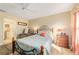 Bedroom with queen bed, recliner, and ensuite bathroom access at 17145 Se 93Rd Yondel Cir, The Villages, FL 32162