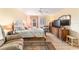 King-size bed, wood dresser, and large TV in this bedroom at 17145 Se 93Rd Yondel Cir, The Villages, FL 32162