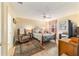 Bright bedroom with a queen-size bed, recliner, and large TV at 17145 Se 93Rd Yondel Cir, The Villages, FL 32162