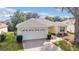 Single-story house with white garage door and well manicured lawn at 17145 Se 93Rd Yondel Cir, The Villages, FL 32162