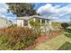 Well-maintained yellow house with sunroom and neatly landscaped yard at 17145 Se 93Rd Yondel Cir, The Villages, FL 32162