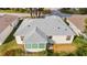 House back, showcasing roof, sunroom, and landscaping at 17145 Se 93Rd Yondel Cir, The Villages, FL 32162