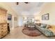 Open concept living room with a large sectional sofa and tiled floors at 17145 Se 93Rd Yondel Cir, The Villages, FL 32162
