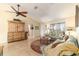 Bright living room featuring a comfy couch and a large wooden cabinet at 17145 Se 93Rd Yondel Cir, The Villages, FL 32162