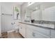 Bathroom featuring granite countertops, double sinks, a large mirror, and modern fixtures at 17523 Promenade Dr, Clermont, FL 34711