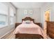 Bedroom featuring wood floors, neutral walls, and a bed with stylish headboard at 17523 Promenade Dr, Clermont, FL 34711