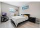 Bedroom with gray walls, wood-look flooring, a TV, and artwork at 17523 Promenade Dr, Clermont, FL 34711
