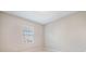 Bedroom with a bright window providing light, and light-colored walls and floors at 17523 Promenade Dr, Clermont, FL 34711