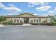 Attractive community clubhouse featuring well-maintained landscaping and inviting architecture at 17523 Promenade Dr, Clermont, FL 34711