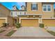 Charming townhome exterior with a brick pathway and well-maintained landscaping and a one car garage at 17523 Promenade Dr, Clermont, FL 34711
