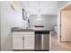 Kitchen area featuring a stainless steel dishwasher, sink, and granite countertop at 17523 Promenade Dr, Clermont, FL 34711