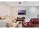 Living room with a large screen TV, comfortable seating, and a ceiling fan at 17523 Promenade Dr, Clermont, FL 34711