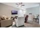 Living room with modern furniture, a ceiling fan, and a wall-mounted TV at 17523 Promenade Dr, Clermont, FL 34711