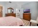 Bedroom featuring wood floors, neutral walls, and stylish furniture at 17523 Promenade Dr, Clermont, FL 34711