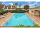 Community pool area with ample seating and well-maintained landscaping at 17523 Promenade Dr, Clermont, FL 34711
