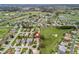 Overhead view of a residential neighborhood with manicured lawns, golf course, and pond at 17652 Se 120Th Ter, Summerfield, FL 34491
