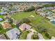 Aerial view of a suburban neighborhood with golf course, manicured lawns, and cul-de-sac at 17652 Se 120Th Ter, Summerfield, FL 34491