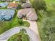 An aerial view of a home with a brick driveway, mature trees, and well-maintained landscaping at 17652 Se 120Th Ter, Summerfield, FL 34491