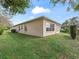 Expansive backyard with lush green grass and a view of the home's exterior, ideal for relaxation at 17652 Se 120Th Ter, Summerfield, FL 34491