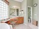 Well-lit bathroom featuring a vanity, a sink, and a glass block window that allows natural light at 17652 Se 120Th Ter, Summerfield, FL 34491