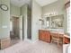 Bright bathroom with tile floors, a vanity area, and walk-in shower at 17652 Se 120Th Ter, Summerfield, FL 34491