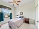 Comfortable bedroom with a ceiling fan, closet, and a window with backyard views at 17652 Se 120Th Ter, Summerfield, FL 34491