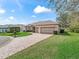 Charming home with brick driveway, two-car garage, and well-manicured lawn at 17652 Se 120Th Ter, Summerfield, FL 34491