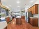 Bright, open kitchen featuring wood floors, an island, stainless appliances, and lots of cabinet space at 17652 Se 120Th Ter, Summerfield, FL 34491