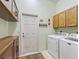 Functional laundry room with cabinetry, washer, and dryer at 17652 Se 120Th Ter, Summerfield, FL 34491