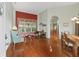 Open living room boasts hardwood floors and an abundance of natural light from the large window at 17652 Se 120Th Ter, Summerfield, FL 34491