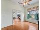 Living room with hardwood floors, ceiling fan, and a window with natural light at 17652 Se 120Th Ter, Summerfield, FL 34491